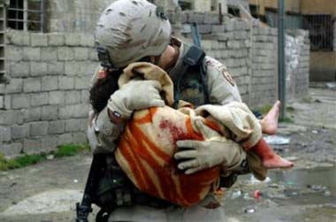 Soldier Embraces injured Iraqi Child