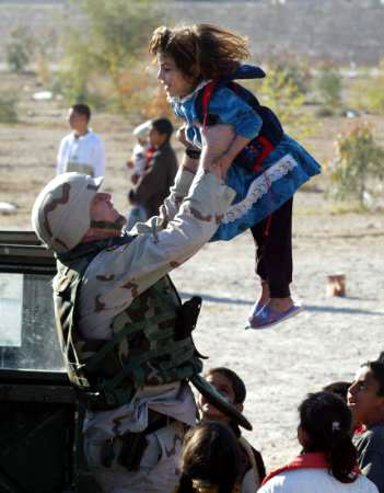 Soldier Lifts-up Iraqi Child