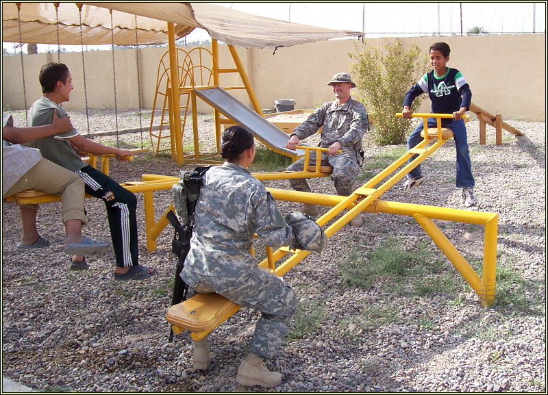 Soldier & Iraqi Kids play on Teeter Totter