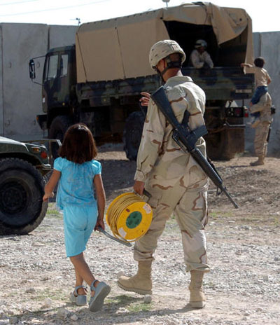 Soldier walking Iraqi child